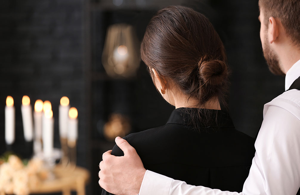 Two people grieve the loss of a loved one