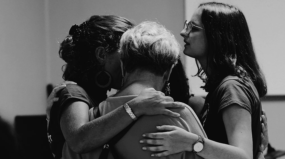 mourning family hugging each other