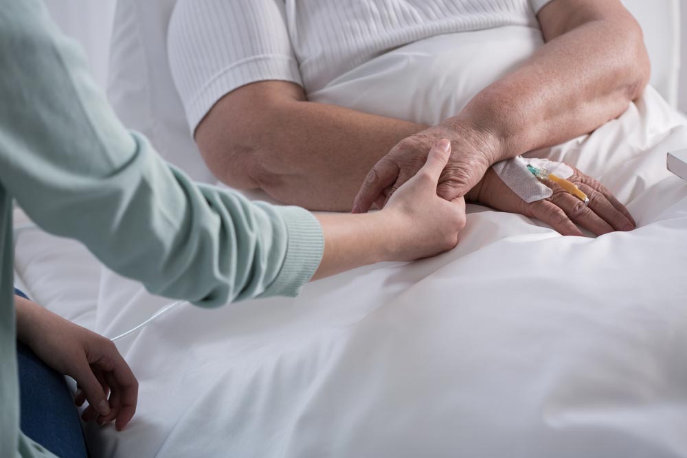 holding hands with a sick person